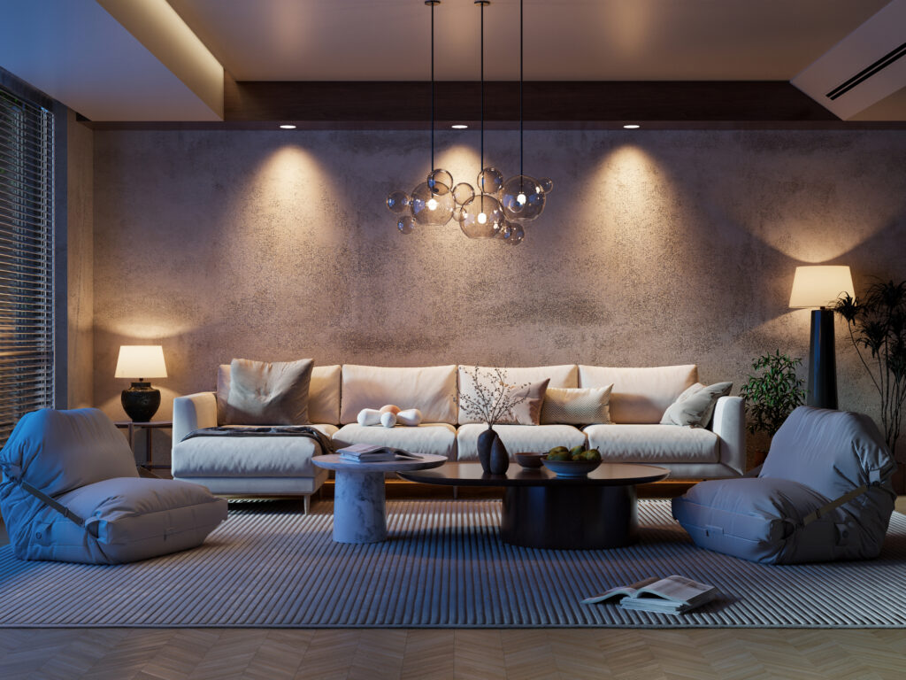 Modern living room with soft ambient lighting, featuring a white sectional sofa, sculptural glass pendant light, neutral-toned decor, low round coffee table, floor cushions, and textured wall with recessed lighting accents.